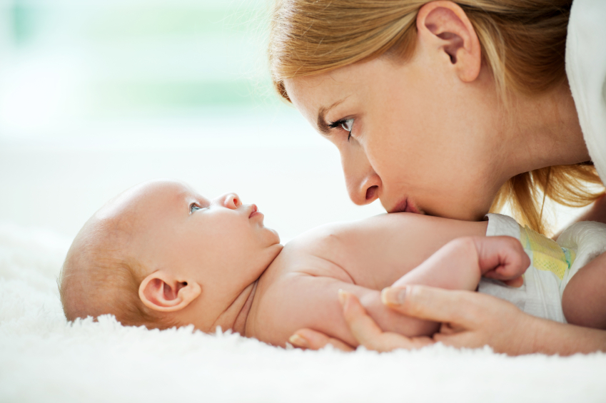 Mother kissing her baby boy.